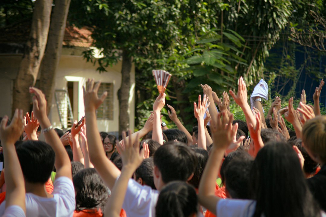 Students celebrating together with hands raised.