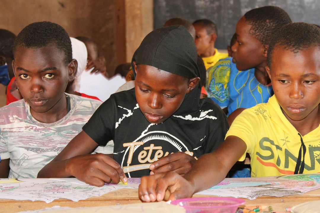 School-age children working together on a colorful paper project.